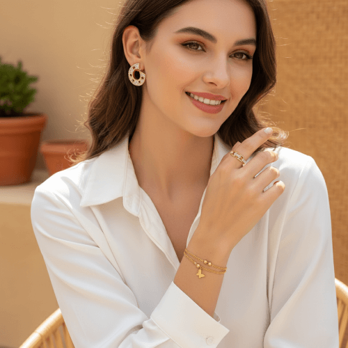 Woman wearing gold jewelry against a warm-toned background