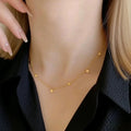 Gold necklace on a mannequin with a black garment